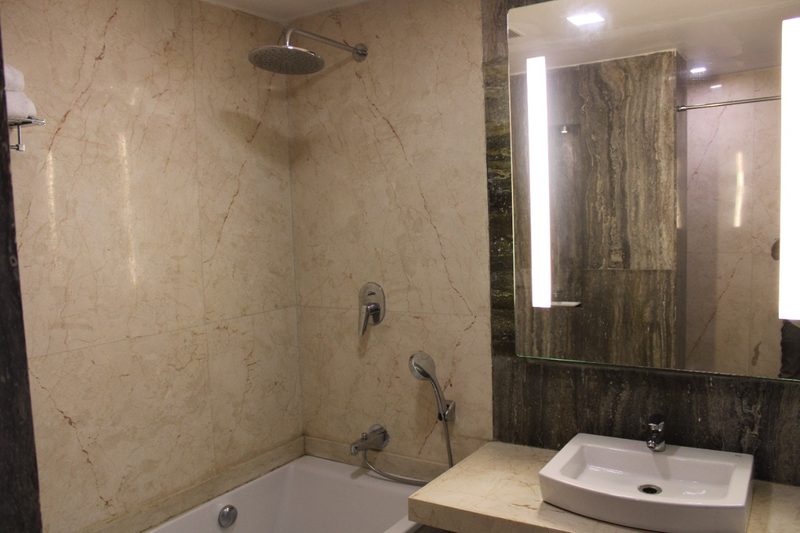 Bathroom with a rain shower, mirror and wash basin