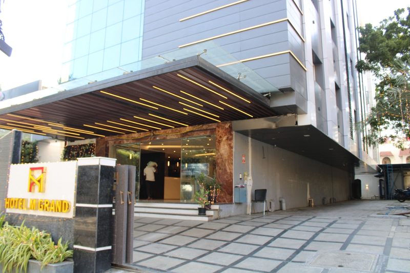 Hotel M Grand signboard beside the covered entrance