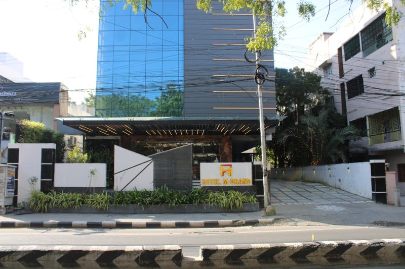 Street view of the Hotel M Grand building and signboard